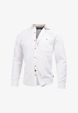 Hvit langermet skjorte laget av lin. Har brune knapper og en lomme. Innvendig hals har en mønstret foring med subtile detaljer.