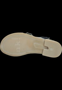 Schwarze Schuhsohle mit einem glatten, beigen Traktionsmuster, einem zentralen Ausschnitt und geprägtem Branding. Strukturierte Oberfläche für Grip und Langlebigkeit.