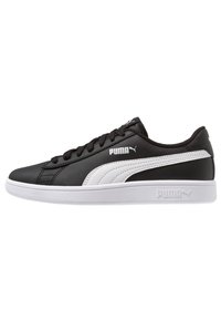 Sneakers in pelle nera con una striscia laterale bianca, chiusura con lacci, punta arrotondata e suola bianca texturizzata. Presenta il logo Puma sui lati e sul tallone.