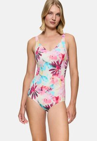 Maillot de bain une pièce en rose pastel avec un motif floral dans des teintes de bleu, violet et jaune. Doté de bretelles spaghetti et d'un décolleté en V.