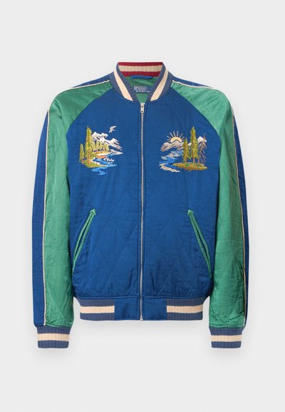 Sinine ja roheline tikanditega bomber-jope, millel on mägede ja jõe motiivid, triibuline krae, mansetid ja vöökoht, ees lukuga ja nurkadega taskud.