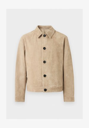 Μπεζ δερμάτινο σακάκι με γιακά, πέντε μαύρα κουμπιά μπροστά, δύο πλαϊνές τσέπες και περίγραμμα τσέπης στο στήθος.