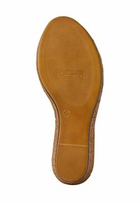 Brown rubber sole with a textured, ridged pattern. Features a logo and a size mark (37) with a subtle raised edge.