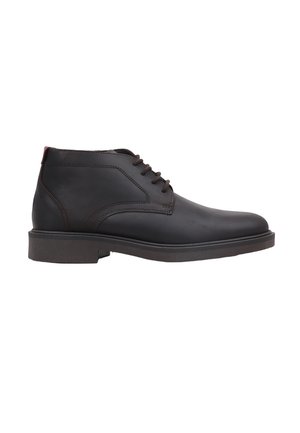 Bottine en cuir noir avec fermeture à lacets et surpiqûres marron sur une semelle en caoutchouc plate, vue de côté extérieur.