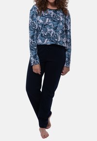 Blomstret langærmet top i nuancer af blå og hvid, parret med marineblå bukser med snøre. Blødt stof med afslappet pasform.