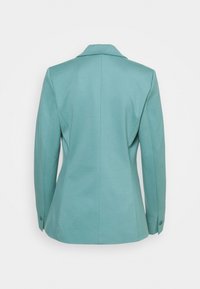 Tailored blazer in light teal, featuring a notched collar, long sleeves, and buttoned cuffs. The fabric has a smooth texture with structured fit.