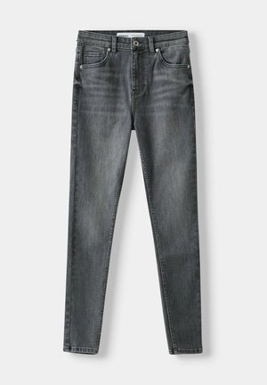 Dunkelgraue Jeans aus Denim mit schmalem Schnitt, fünf Taschen, einem vorderen Knopfverschluss und dezenten Auswaschungen.