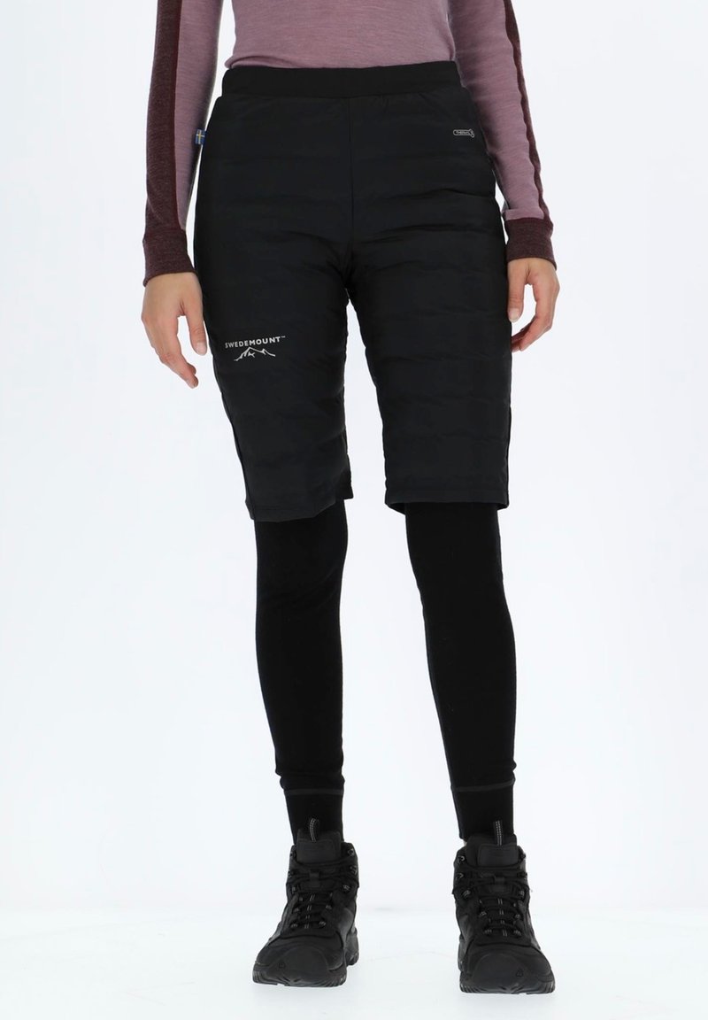 Black insulated shorts with a padded texture, featuring a logo. Paired with fitted black leggings and black footwear.