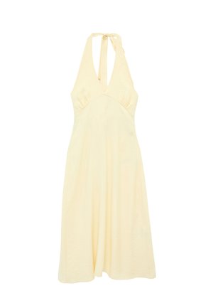 Robe sans manches jaune pâle à col halter avec un décolleté en V profond et une jupe fluide en ligne A, nouée à l'arrière du cou.