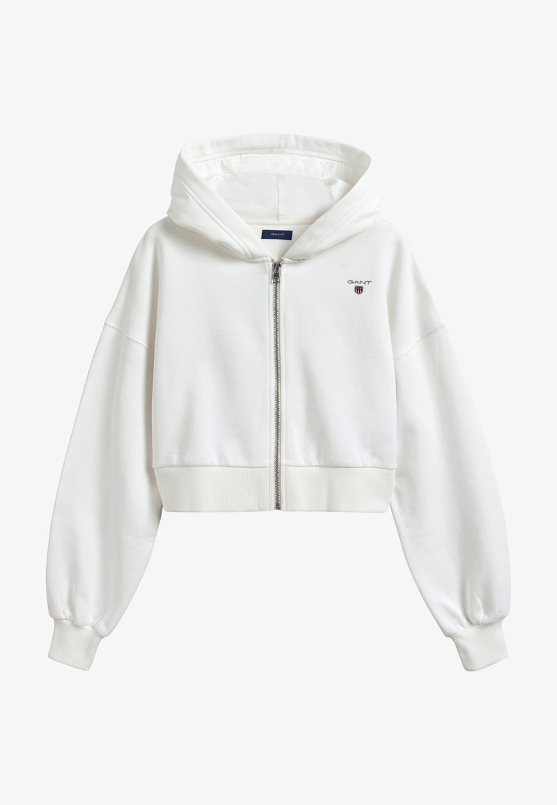 Geknipte witte hoodie van zacht materiaal, met een rits aan de voorkant, lange pofmouwen, geribde boord en een klein logo op de borst.