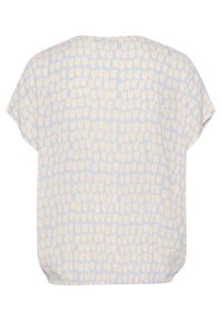Blouse bleu clair à manches courtes, présentant un motif abstrait à pois crème, un ourlet élastique et un tissu doux et léger.