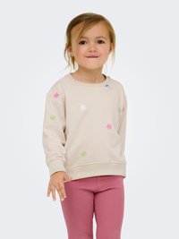 Beige sweatshirt met kleurrijke bloemenborduursels in roze, groen en blauw. Gepaard met roze geribde leggings, met een ronde hals en boorden.