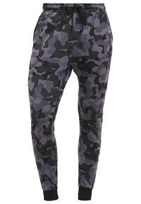 Camo-mönstrade joggers i lätt tyg, med nyanser av svart och grått, elastisk midja med dragsko och ribbade ärmslut.