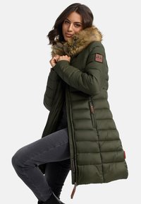 Olive green long puffer coat with a faux fur collar, quilted design, zippered pockets, and branded patch on the upper arm.