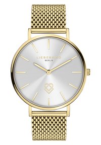 Montre en maille dorée avec un cadran rond argenté à motif radié, marqueurs d'heure minimalistes et un accent de logo. Fini lisse et poli.