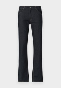 Tmavomodré riflové nohavice s rozšíreným strihom na nohaviciach, žltým prešitím, zapínaním na gombík a piatimi vreckami. Hladká textúra, štandardný strih.