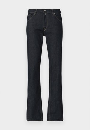 Tmavě modré džíny z denimu s rozšířeným střihem nohavic, žlutým šitím, zapínáním na knoflík a pěti kapsami. Hladká textury, standardní střih.