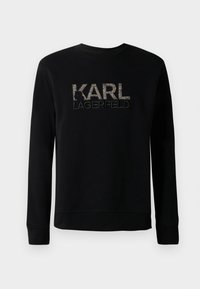 Čierna mikina s dlhým rukávom a textúrovaným vyšitým logom "KARL LAGERFELD" na hrudi, s jednoduchým okrúhlym výstrihom.