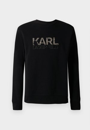Melna garām piedurknēm svītrkrekls ar tekstūrētu "KARL LAGERFELD" logotipu izšūtu uz krūtīm, ar vienkāršu apaļu kakla izgriezumu.