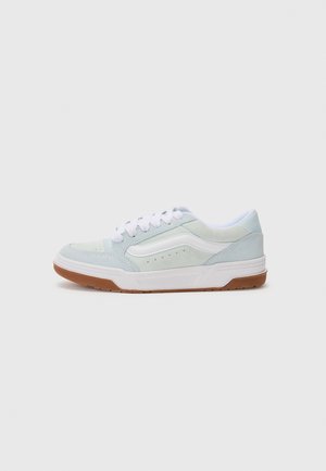 Low-top sneaker with a mint green and white suede upper, white laces, subtle perforations, and a brown rubber sole.