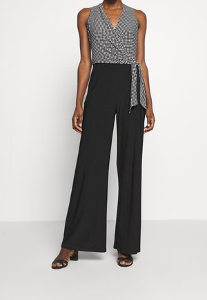 Sort jumpsuit med ærmeløs design, V-udskæring og mønstret overdels med bindebånd. Bukser med vide ben fuldender den moderne silhuet.