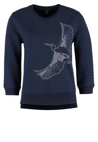 Navy quilted sweatshirt with long sleeves, rounded neckline, and a white bird design on the front. Features ribbed cuffs and hem.