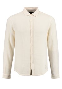 Camisa de manga larga en tejido texturizado blanco roto, con botón frontal, cuello clásico y detalle bordado en el dobladillo.