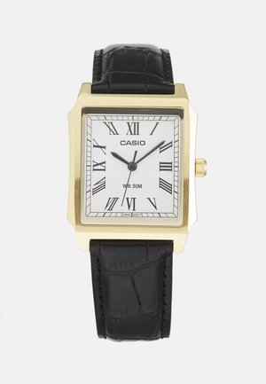 Square Casio watch with a gold tone case, white face, Roman numerals, black leather strap, and a water resistance of 50 meters.