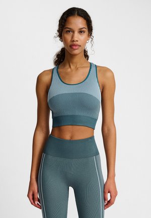 Teal ribbed sports bra with a rounded neckline and wide straps, paired with matching leggings featuring white side stripes. Both garments are fitted.