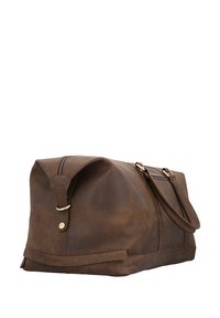 Brown leather duffel bag with a smooth texture, zip closure, and a detachable shoulder strap. Features brass hardware accents.