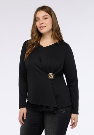 Czarny długi rękaw z dekoltem w kształcie V, z przewróconym wzorem w talii i złotym guzikiem po lewej stronie. Miękki materiał.