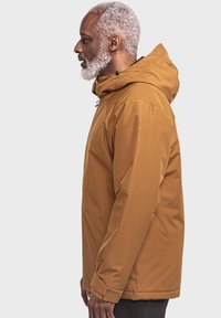 Braune, wasserfeste Jacke mit Kapuze, ausgestattet mit einem Reißverschluss, verstellbaren Kordeln und einer lockeren Passform. Sanfte, glatte Textur.