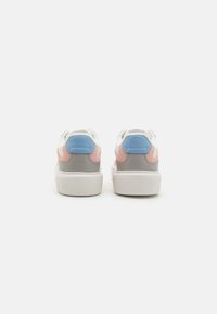 Sneakers with a white base, gray suede, pink and blue accents, rounded toe, and textured rubber sole; lace-up design with padded collar.