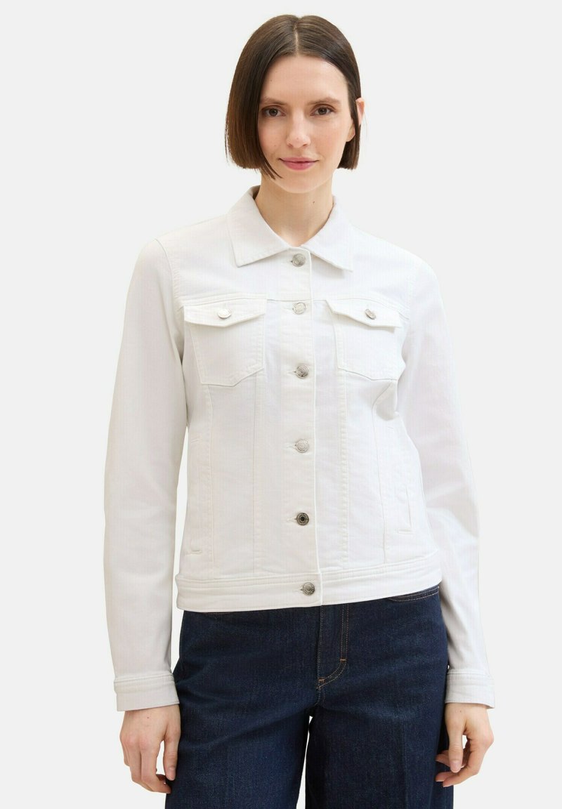 White denim jacket with a button-up front, pointed collar, and two chest pockets. The design features a cropped length and long sleeves.