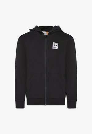 Haut de sweatshirt noir à zip avec une poche kangourou, des poignets et un ourlet côtelés. Présente un logo Timberland blanc sur la poitrine. Texture de tissu douce.