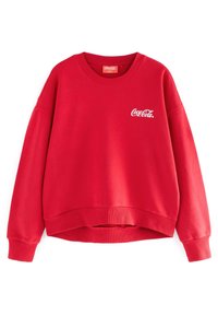 Sweat-shirt rouge en tissu doux avec un col rond, des épaules tombantes et un ourlet court. Présente un logo "Coca-Cola" blanc sur la poitrine.