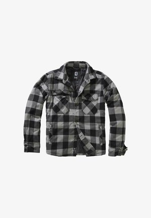 Giacca in flanella con motivo a quadri nero e grigio, con due tasche frontali, chiusura con bottoni e collo da camicia. Il tessuto è morbido con una texture liscia.