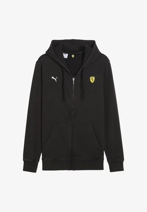 Juodas zip-up džemperis su gobtuvu, pagamintas iš minkštos medžiagos. Ant krūtinės yra baltas Puma logotipas ir geltonas Ferrari skydas. Priekiniai kišeniai.