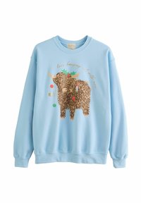 Lyseblå sweatshirt med grafik af en smilende, langhåret highland ko dekoreret med kristtorn og hængende julekugler.