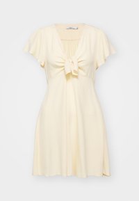 Short-sleeve, light yellow dress with a tie front. Soft, textured fabric, V-neckline, and flared skirt, offering a relaxed fit.