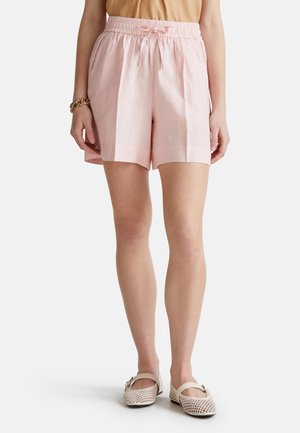 Light pink linen shorts with an elastic waistband and drawstring. Features two side pockets and a loose fit.