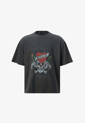 Schwarzes Baumwoll-T-Shirt im Oversized-Design, mit einem Grafikdruck eines Schädels mit einem Herz und Bannertext. Kurzärmel und Rundhalsausschnitt.