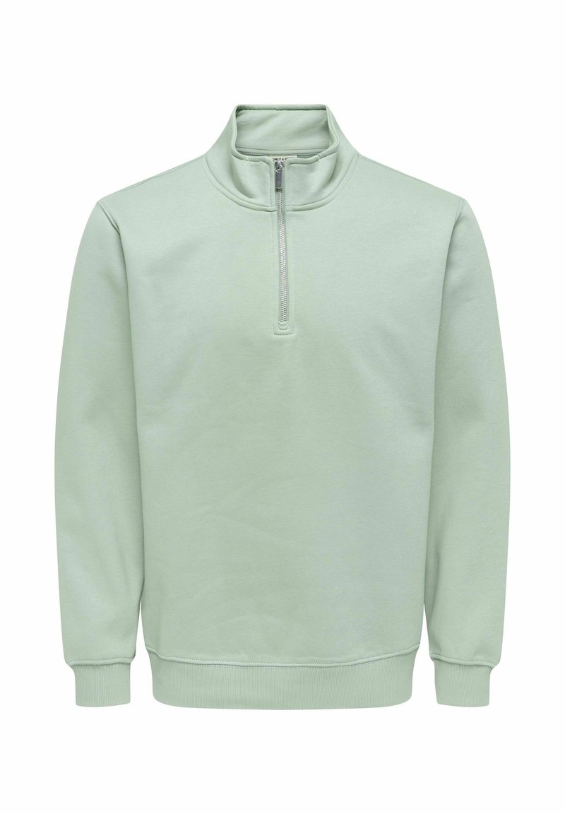 Lysegrøn pullover sweatshirt med høj hals og lynlås foran. Fremstillet af blødt stof med ribstrikkede manchetter og en afslappet pasform.
