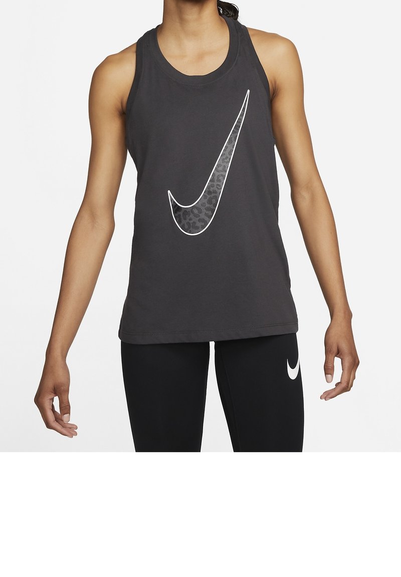 Schwarzes sportliches Tanktop mit großem weißem Nike-Swoosh-Logo; glatter Baumwollmischstoff; ärmelloses Design; kombiniert mit schwarzen Leggings.