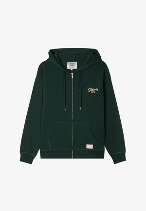 Grüner Zip-Hoodie aus weichem Material, mit einer Fronttasche, Kordelzugkapuze und goldgesticktem Logo auf der linken Brust.