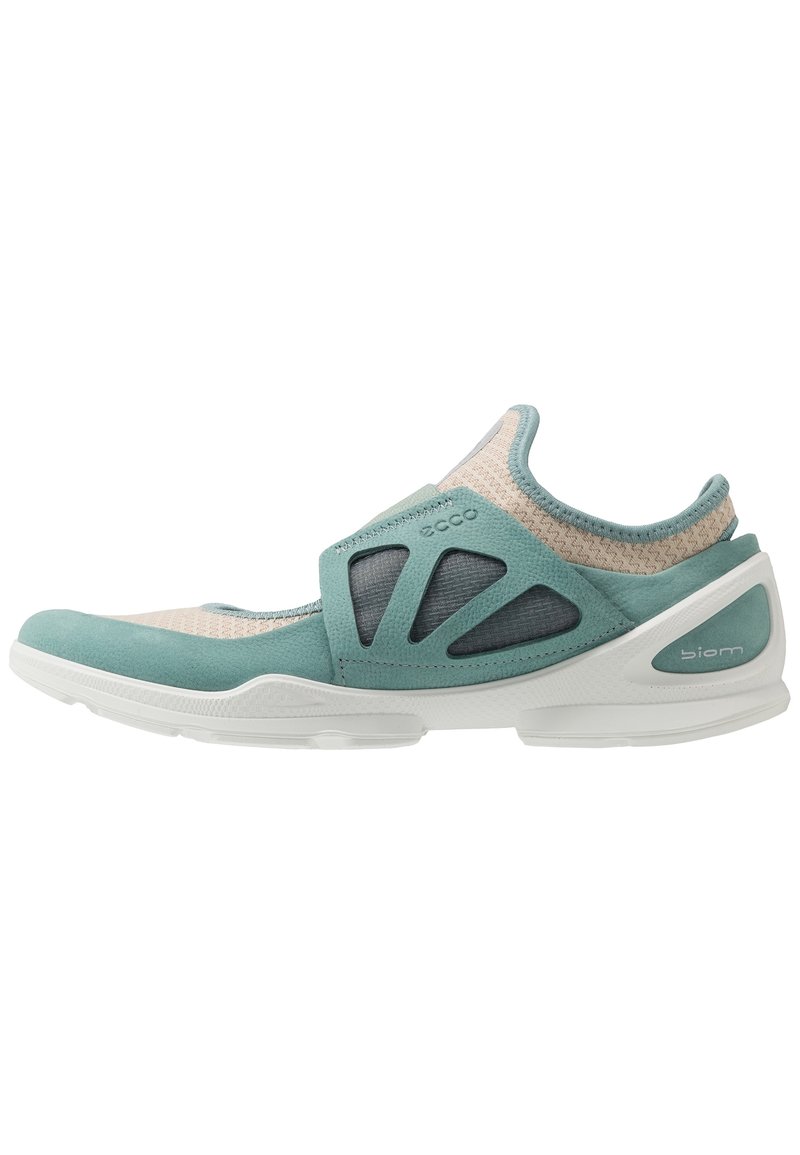 Lightweight aqua and beige athletic shoe with mesh fabric, cushioned sole, and elastic strap. Features soft suede accents and ventilation openings.
