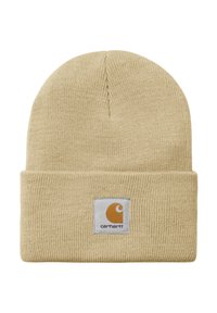 Gorro de punto beige claro con textura acanalada y puño doblado. Presenta un parche cuadrado con un logo en naranja y blanco.