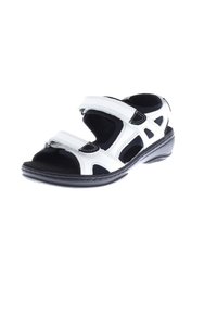 White and black sandals with adjustable Velcro straps, open design, textured upper, and a black rubber sole featuring a slight heel.