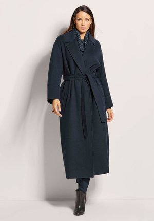 Navy wool trench coat with a wrap design, wide lapels, belt at the waist, side pockets, and long sleeves. Smooth texture and classic cut.