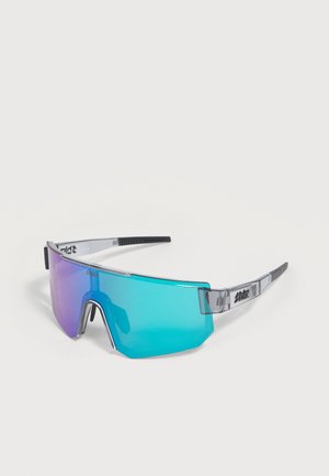 Sporty wraparound sunglasses with a single blue-purple tinted lens and transparent gray arms featuring black grip tips and branding.